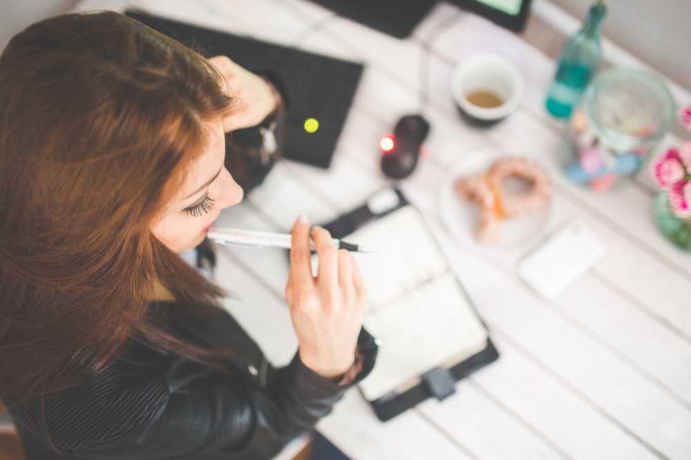 Young woman writing a diary